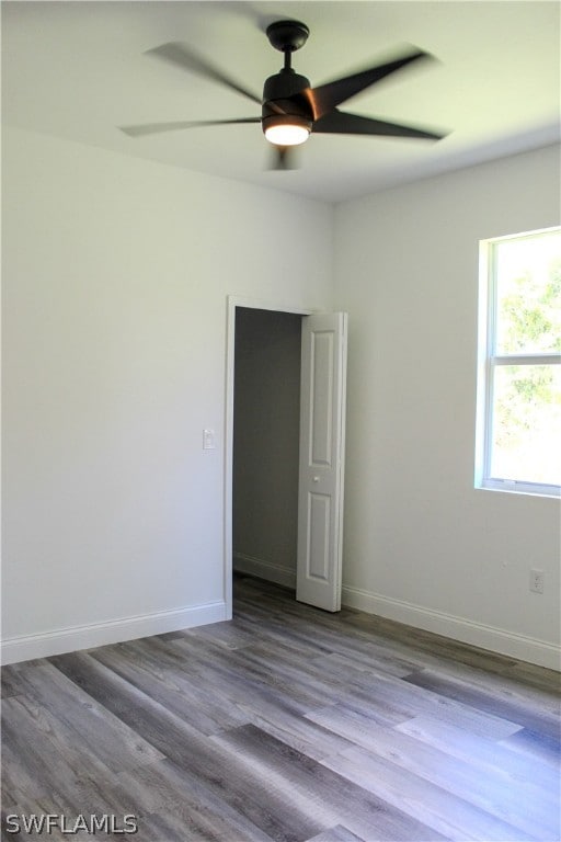 spare room with wood-type flooring and ceiling fan