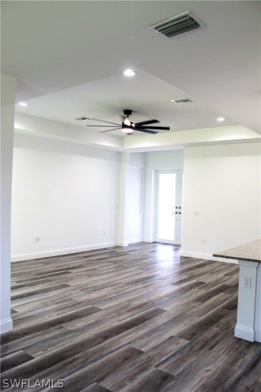 spare room with ceiling fan and dark hardwood / wood-style flooring