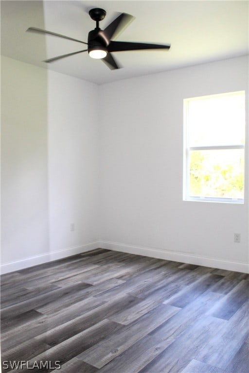 spare room with dark hardwood / wood-style floors and ceiling fan