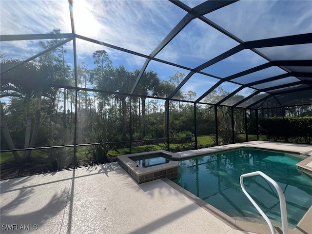 view of swimming pool featuring a patio area, a lanai, and a pool with connected hot tub