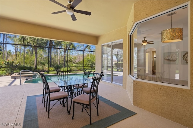 sunroom / solarium featuring ceiling fan and a pool