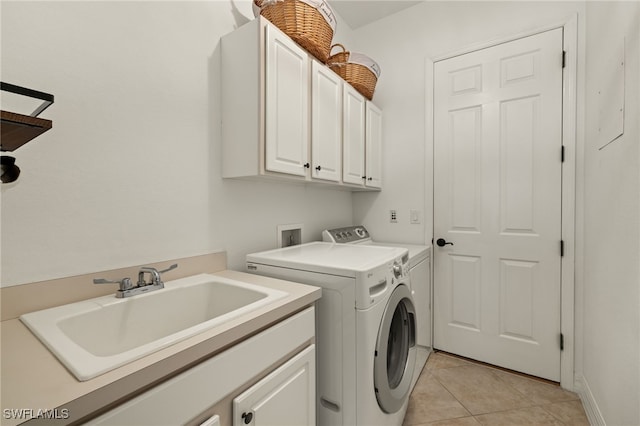 clothes washing area featuring cabinets, independent washer and dryer, sink, and light tile patterned floors