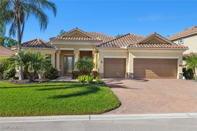 mediterranean / spanish-style house with a front yard and a garage