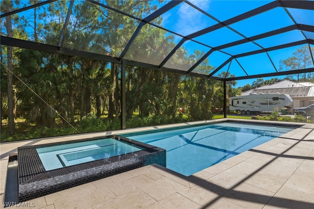 view of swimming pool with an in ground hot tub, a patio, and glass enclosure