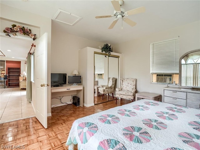 bedroom with cooling unit, ceiling fan, and light parquet floors