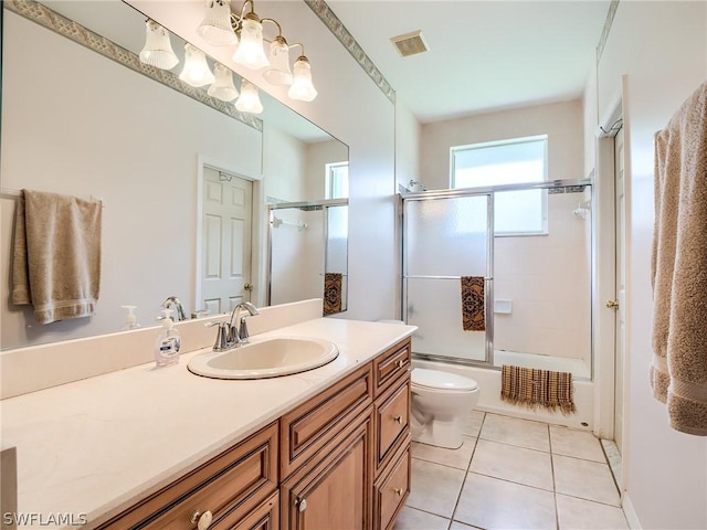 full bathroom featuring toilet, tile patterned flooring, vanity, and combined bath / shower with glass door