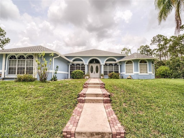 mediterranean / spanish-style house with a front yard