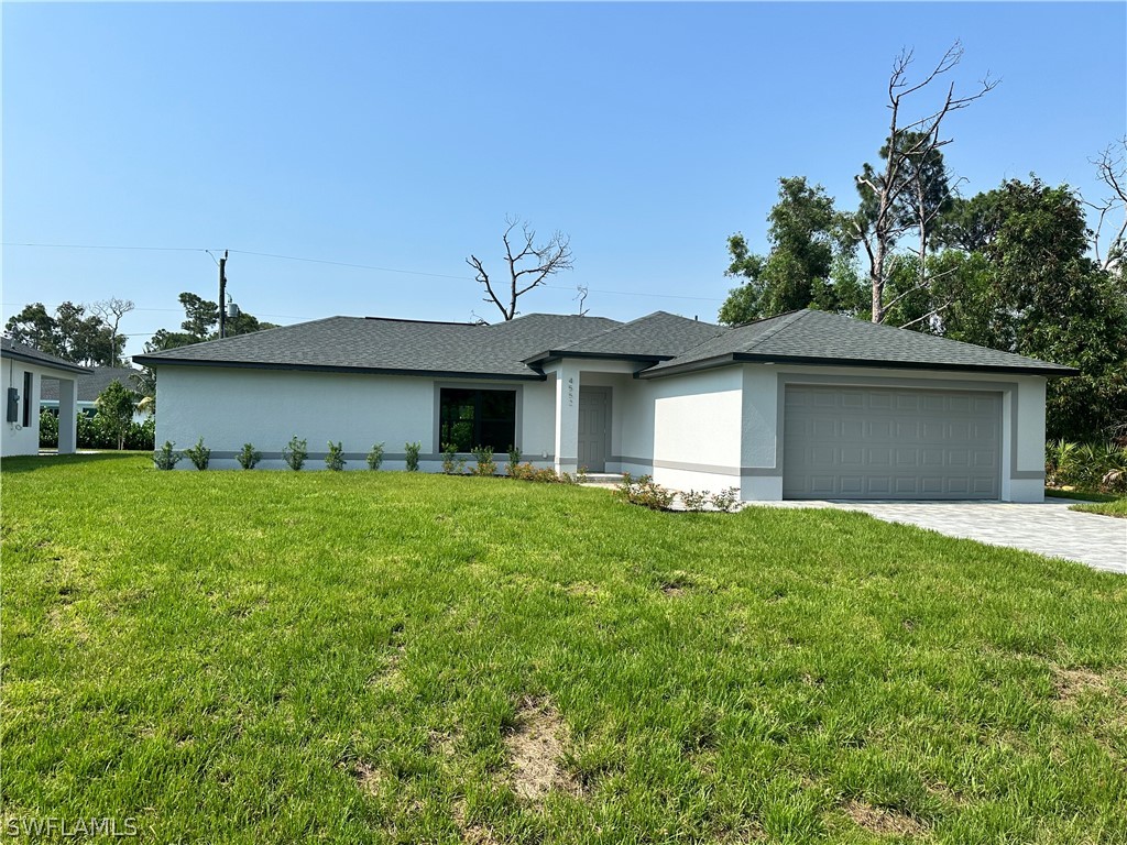 view of front facade with a garage and a front lawn