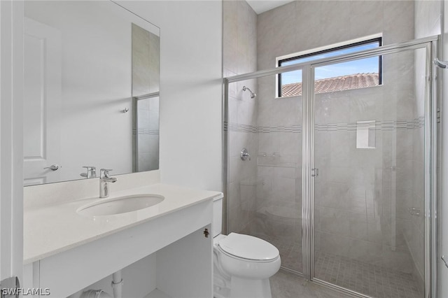 bathroom featuring vanity, toilet, and walk in shower