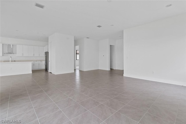 unfurnished living room featuring sink