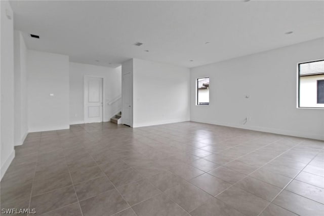 unfurnished room with light tile patterned floors