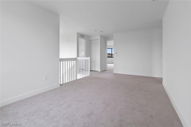 spare room with light colored carpet