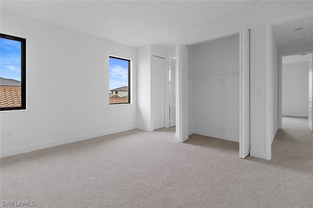 unfurnished bedroom featuring light colored carpet