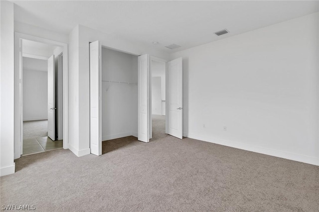 unfurnished bedroom with a closet and carpet