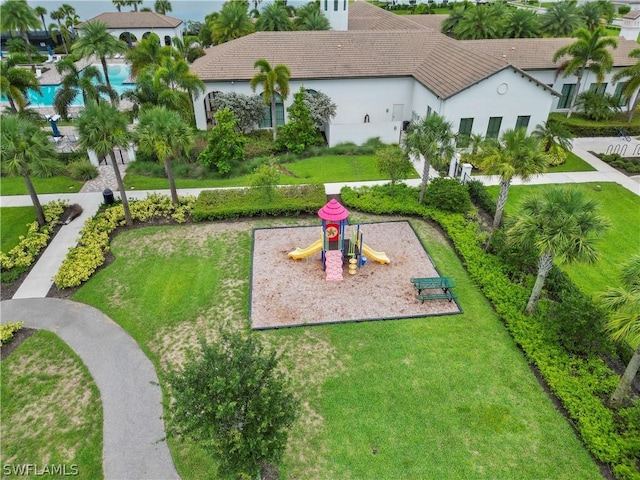 view of property's community with a yard and a playground