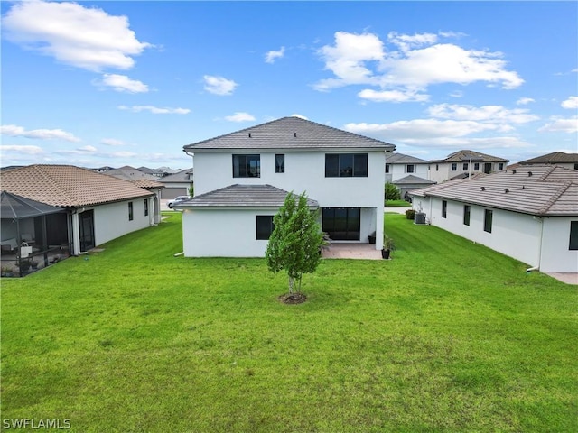 rear view of house with a patio and a yard