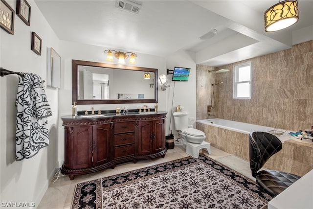 full bathroom featuring tile floors, double sink vanity, toilet, and tiled shower / bath combo