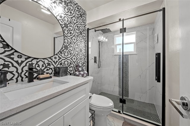 bathroom featuring a shower with shower door, vanity, toilet, and tile floors