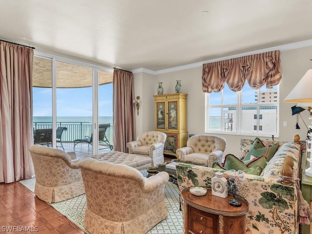 living room featuring crown molding, plenty of natural light, a water view, and parquet flooring