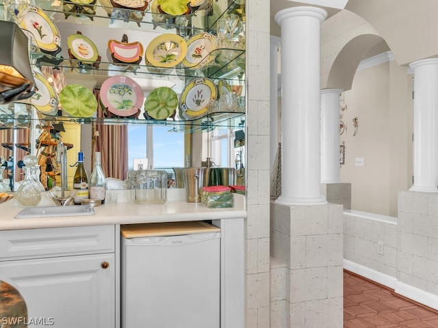 bar with dishwasher, white cabinetry, and crown molding