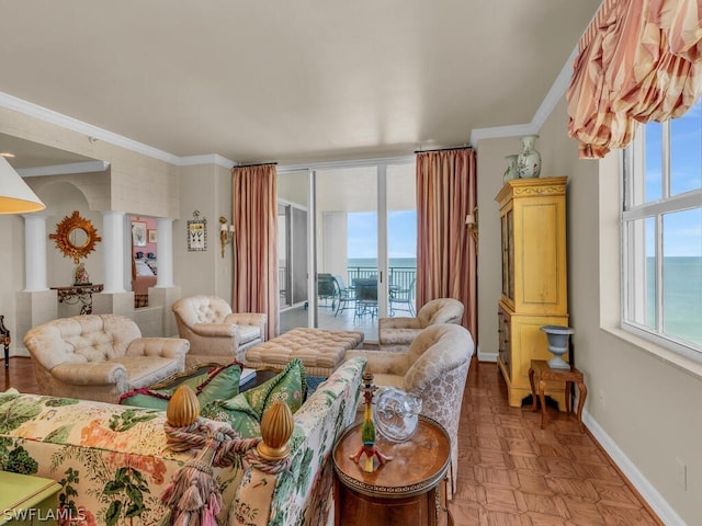 living room with decorative columns, light parquet flooring, a water view, and ornamental molding