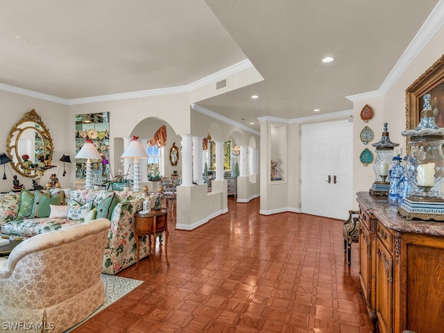 living room featuring ornate columns, crown molding, and light parquet flooring