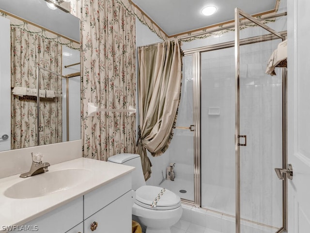 bathroom featuring tile patterned flooring, a shower with door, vanity, and toilet