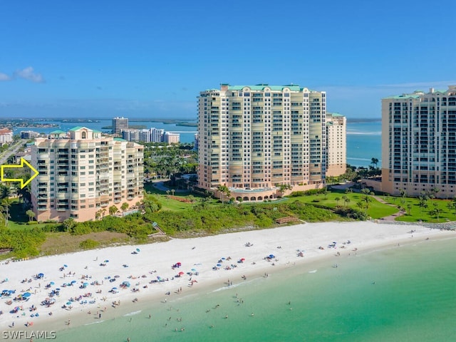 bird's eye view with a water view and a view of the beach