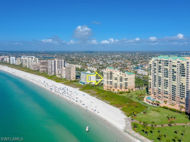 drone / aerial view with a water view and a beach view