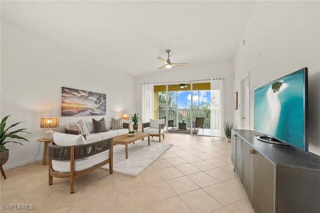 tiled living room with lofted ceiling and ceiling fan