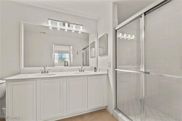 bathroom with vanity, an enclosed shower, and tile patterned flooring