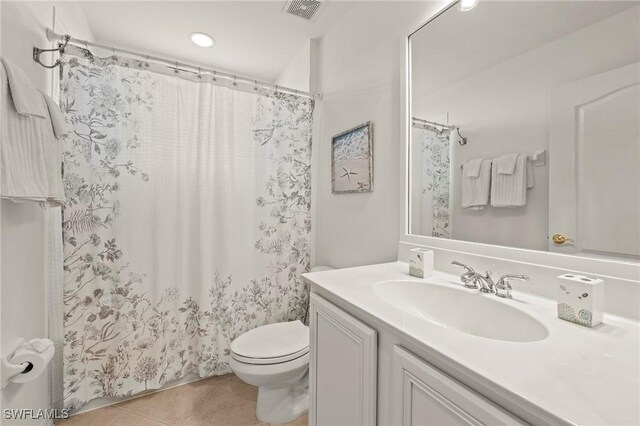 bathroom with tile patterned flooring, vanity, a shower with curtain, and toilet