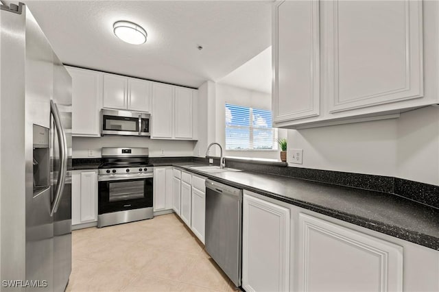 kitchen with sink, white cabinets, and appliances with stainless steel finishes