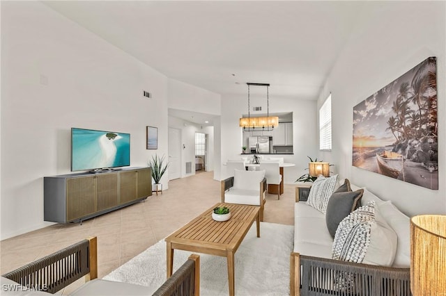 living room featuring vaulted ceiling and a chandelier