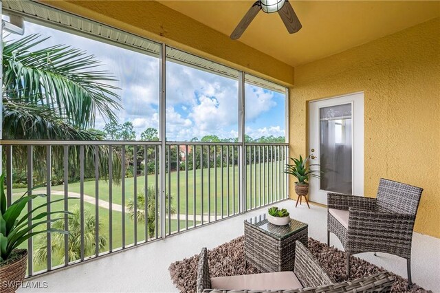 sunroom / solarium featuring ceiling fan