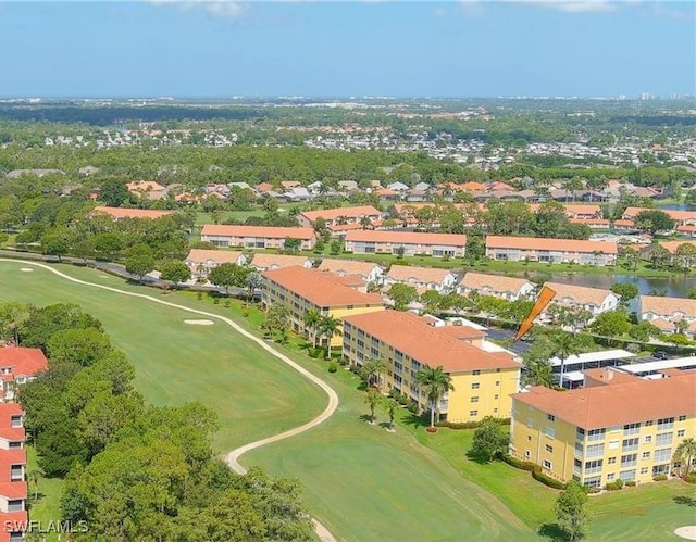 birds eye view of property with view of golf course and a water view