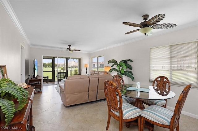 tiled dining area with ceiling fan and crown molding