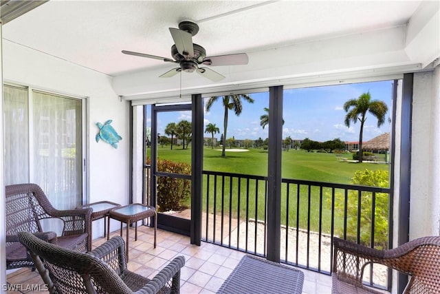 sunroom / solarium with a wealth of natural light and ceiling fan