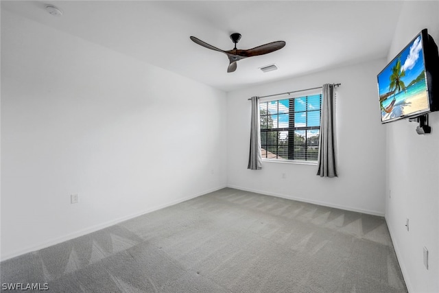 spare room with carpet and ceiling fan