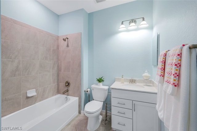 full bathroom with tiled shower / bath combo, toilet, and vanity