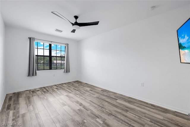 unfurnished room with ceiling fan and light wood-type flooring