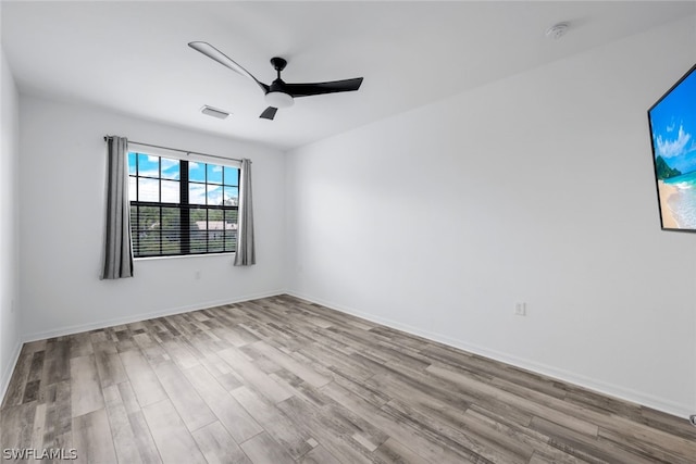 2375 Montserrat Ln Unit 202, Naples, FL 34120 - spare room with visible vents, a ceiling fan, baseboards, and wood finished floors
