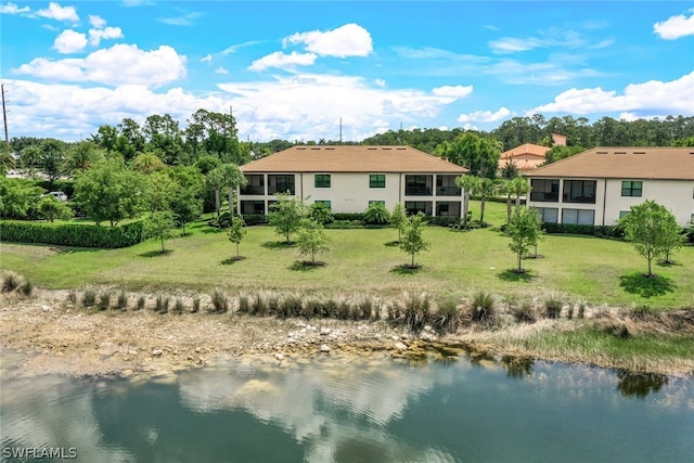 back of property featuring a yard and a water view