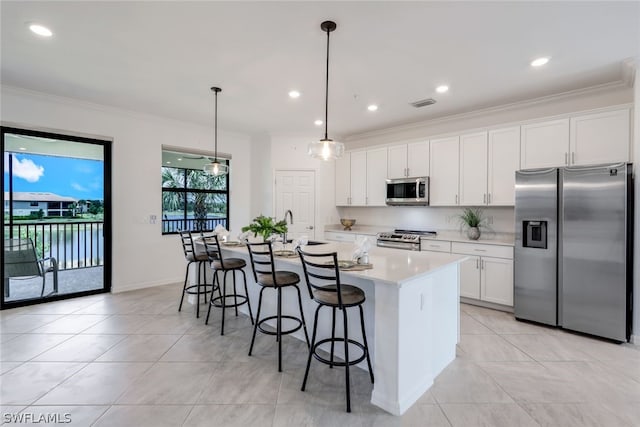 2375 Montserrat Ln Unit 202, Naples, FL 34120 - kitchen with light countertops, appliances with stainless steel finishes, a kitchen island with sink, and light tile patterned flooring