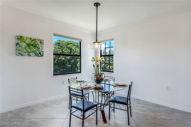 dining room featuring tile patterned floors and ornamental molding