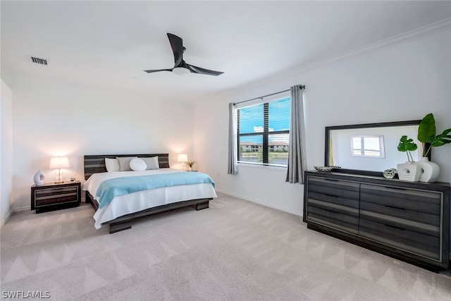 bedroom featuring ceiling fan, crown molding, and light carpet