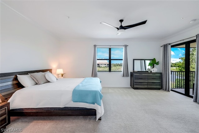 carpeted bedroom featuring access to exterior, ceiling fan, and ornamental molding