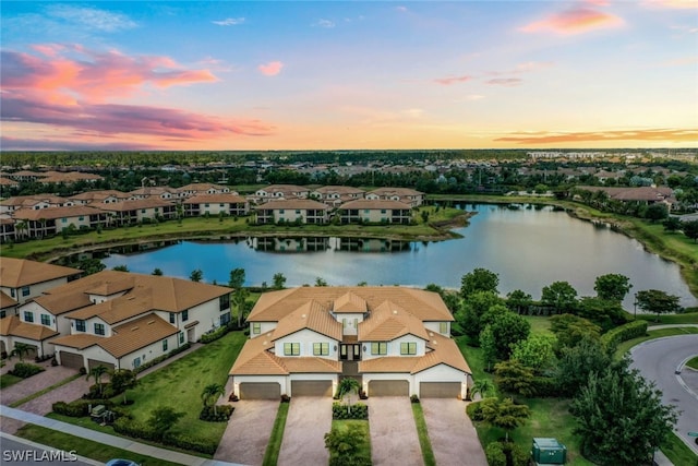 aerial view at dusk with a water view