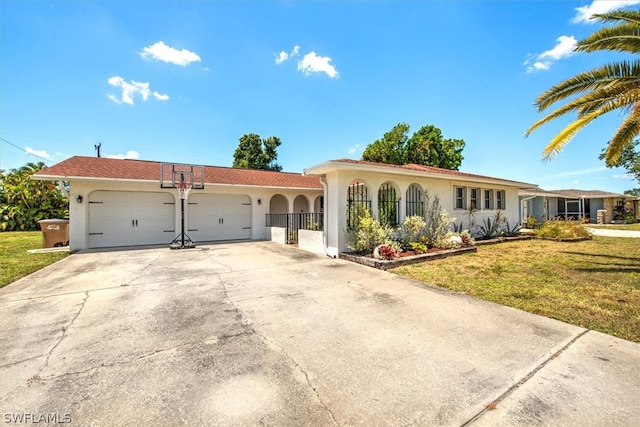 view of front of property with a garage and a front lawn