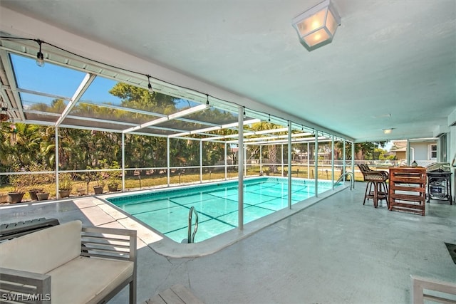 view of pool with a patio and a lanai